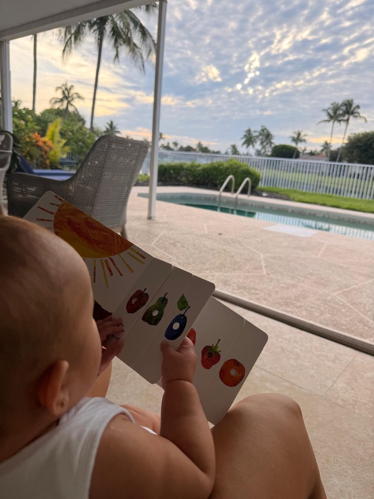 Reading a board book by the pool